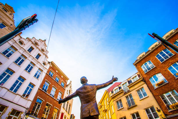 Brussels (Bruxelles), Belgium - March 21, 2018 - Place de la Vieille Halle aux Bles with statue of the famous singer Jacques Brel, which entitled L'envol (The Flight) stock photo