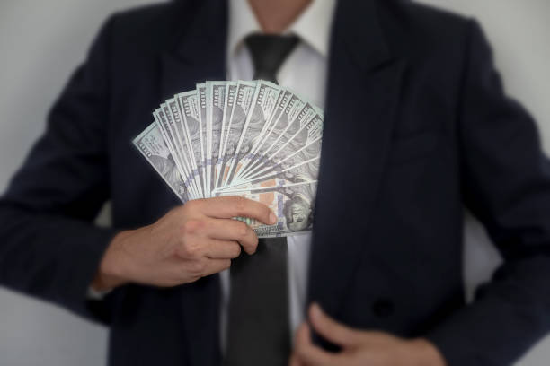 istock Business Man Displaying a Spread of dollars. 1028875940