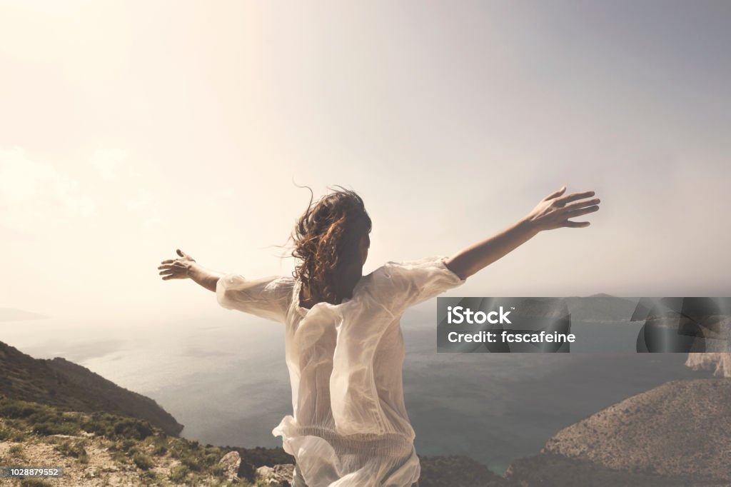 woman taking a breath in front of a spectacular view One Woman Only Stock Photo