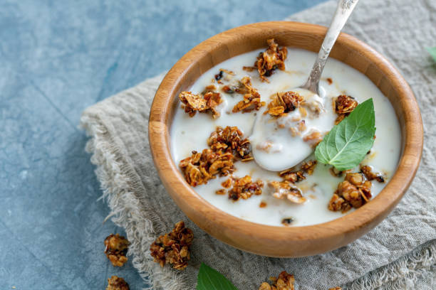 istock Natural yogurt with oat flakes and nuts in honey. 1028882856