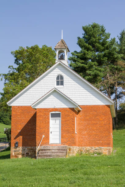 istock Old Brick One Room Schoolhouse With Bell On Roof 1028883242
