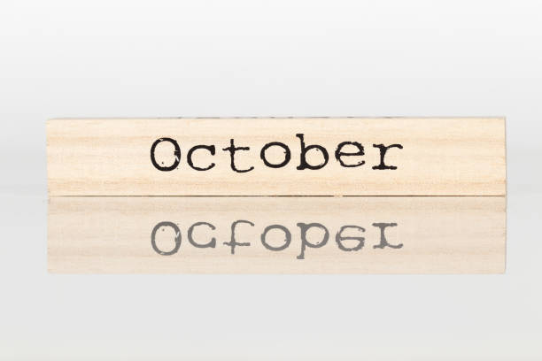 istock wooden cube with an inscription October on a white background 1028885574