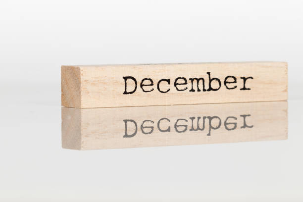istock a wooden cube with an inscription December on a white background 1028885646