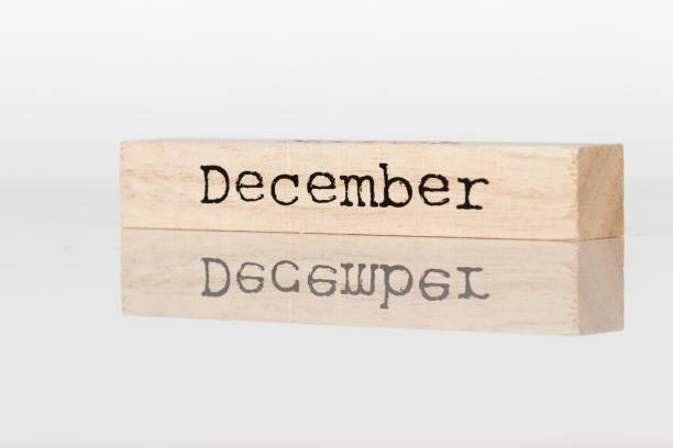 istock a wooden cube with an inscription December on a white background 1028885672