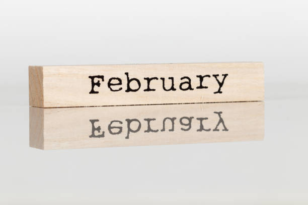 istock wooden cube with inscription February on white background 1028885780