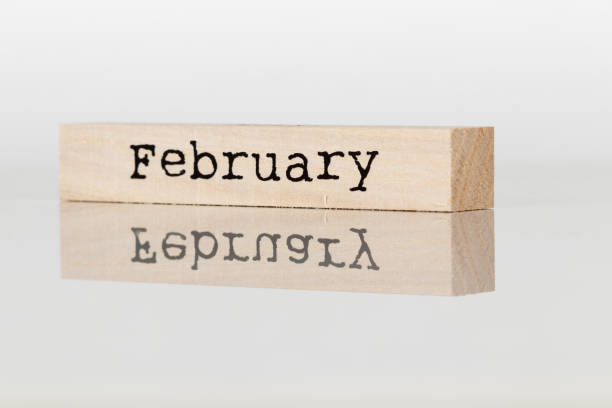 istock wooden cube with inscription February on white background 1028885840