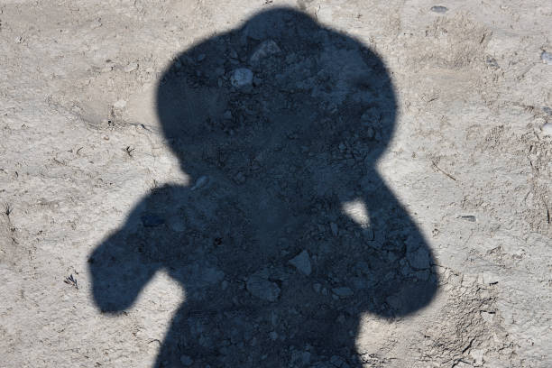 istock Shadow of a woman wearing a hat 1028888922