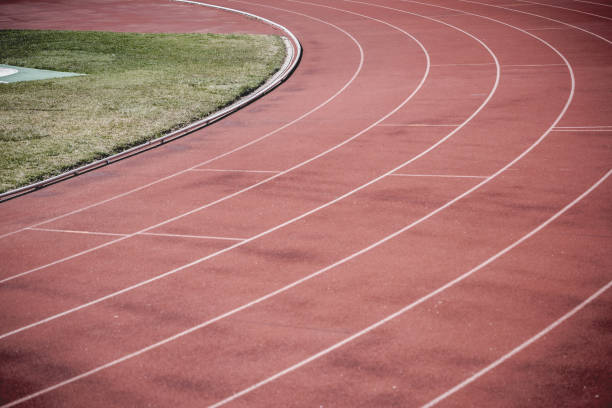 istock Athlete Track or Running track lines with green grass 1028889418