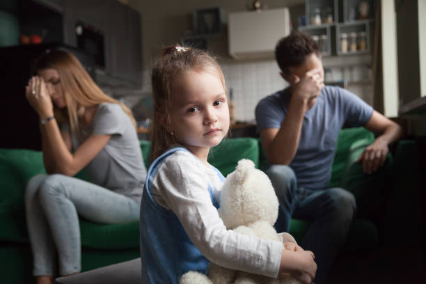 Frustrated girl tired of parents fights, child and divorce concept Frustrated little girl upset tired of parents fight looking at camera, portrait of sad preschool kid daughter suffers from family mom and dad arguments or lack of attention, child and divorce concept child sadness stock pictures, royalty-free photos & images