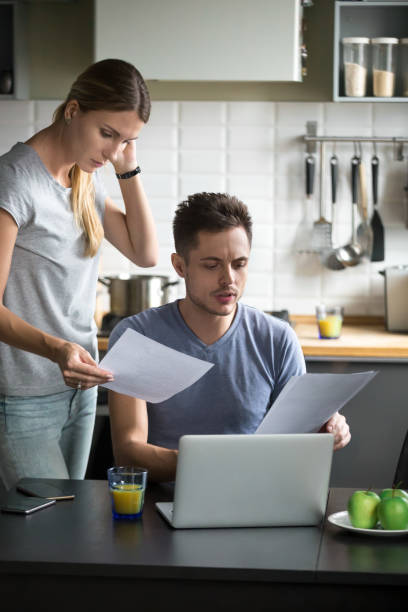 istock Confused young couple worried checking domestic bills having financial problems 1028900570