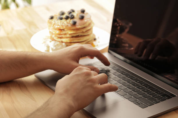 istock Young male hands working on laptop at home 1028904436