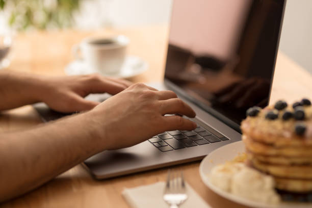istock Young male hands working on laptop at home 1028904492