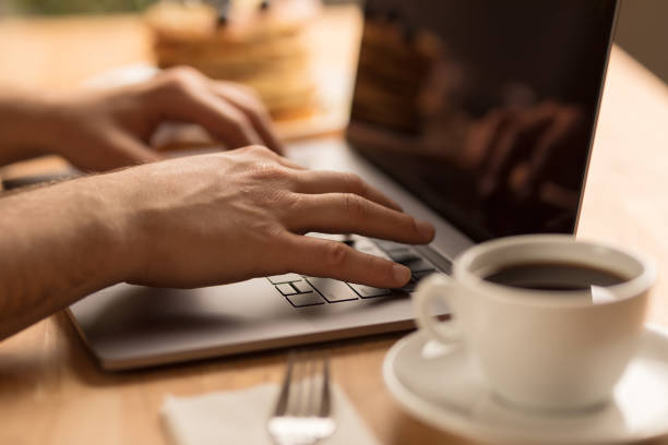 istock Young male hands working on laptop at home 1028904652