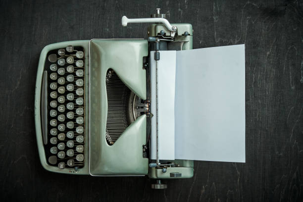 istock beautiful old gray typewriter on a black table 1028907490