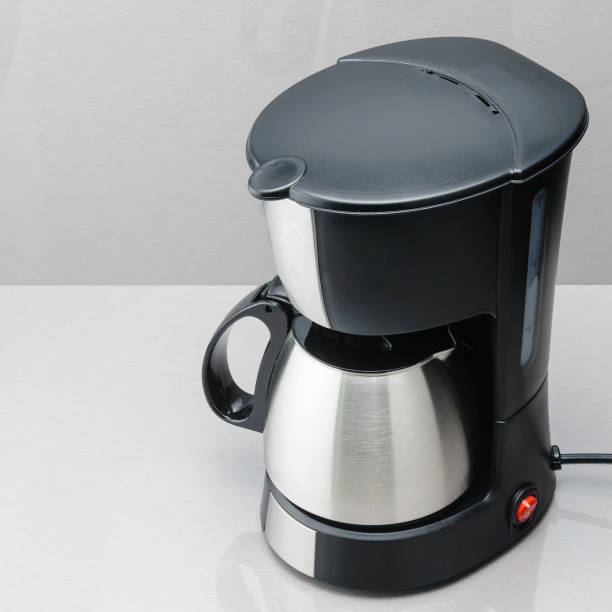 istock Coffee machine with pot on the grey mirror background. 1028909958