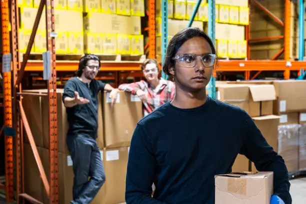 Photo of An industrial warehouse worker being the target of bullying