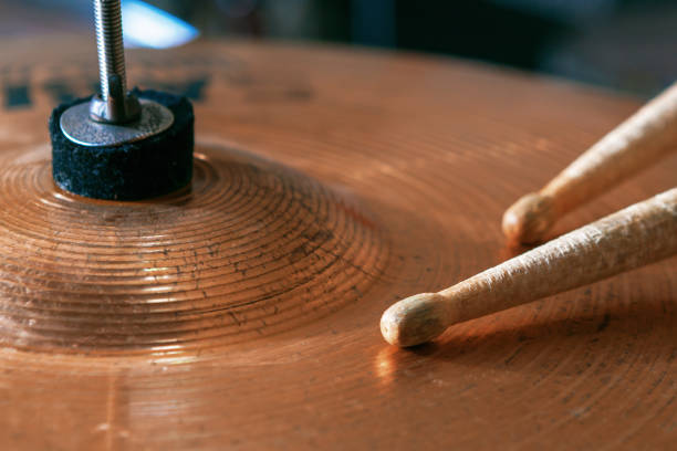 istock Pair of drumsticks lying on cymbal. 1028934140