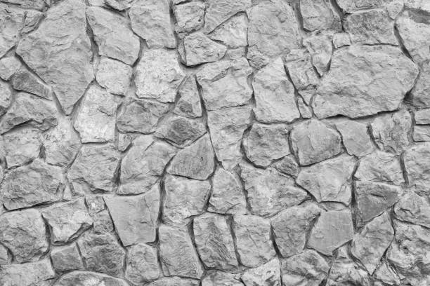 istock Grey stone wall texture. Ancient natural cobblestone road as background. 1028934680