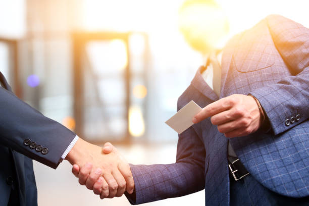 Successful business people shaking hands  at the meeting stock photo