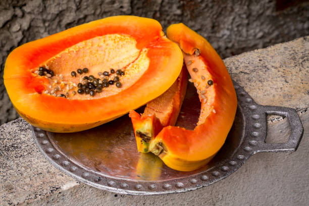 Juicy papaya on a metal tray stock photo