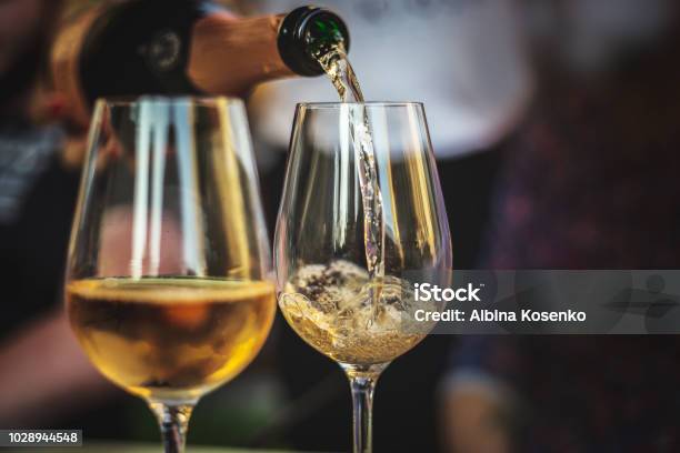 Pouring Rose Champaign Into A Glass Stock Photo - Download Image Now - Champagne, Wine, Wineglass