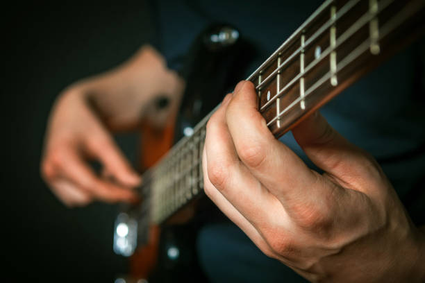 istock Rock guitarist practicing with bass guitar. 1028944744