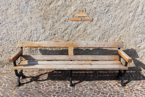 istock Wooden bench on cobbled street 1028945090
