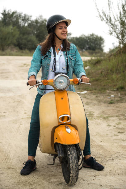 istock Young lady with orange scooter 1028945772
