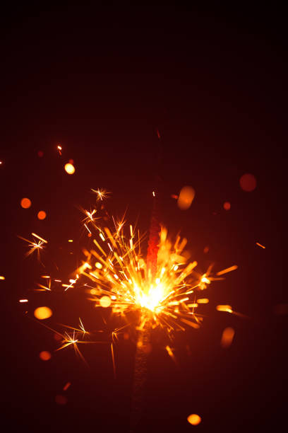 istock Christmas sparkler in haze with red light 1028957206