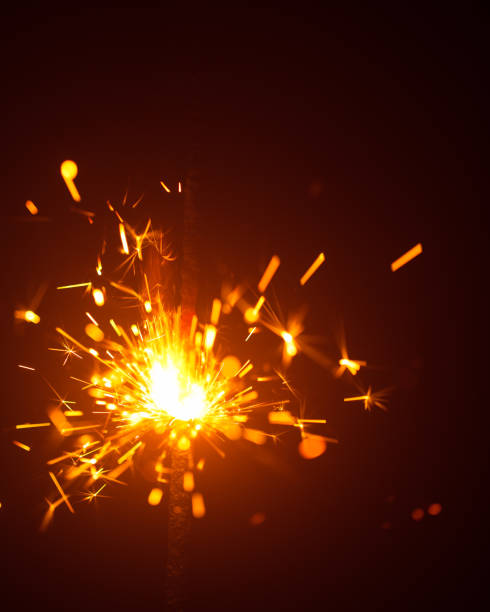 istock Christmas sparkler in haze with red light 1028957514