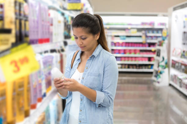 istock Mid adult woman shops for shampoo 1028962070