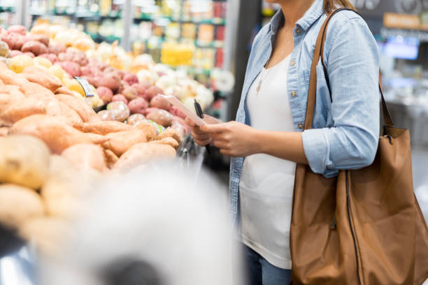 istock Woman shops for produce 1028962120