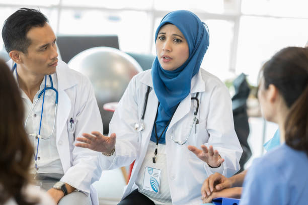 istock Serious doctor discusses patient during staff meeting 1028962412