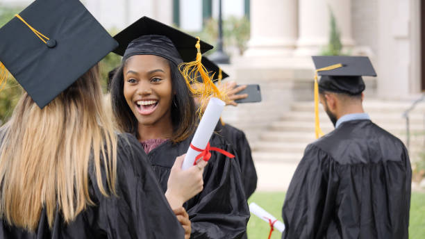 istock Excited female graduate talks to classmate after ceremony 1028962502