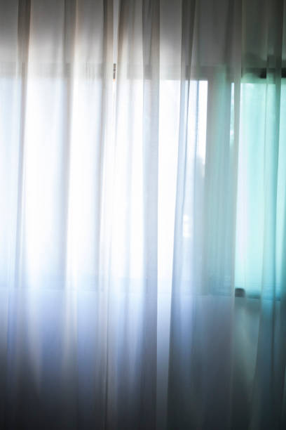 Hotel bedroom net curtains window with soft dalylight light.