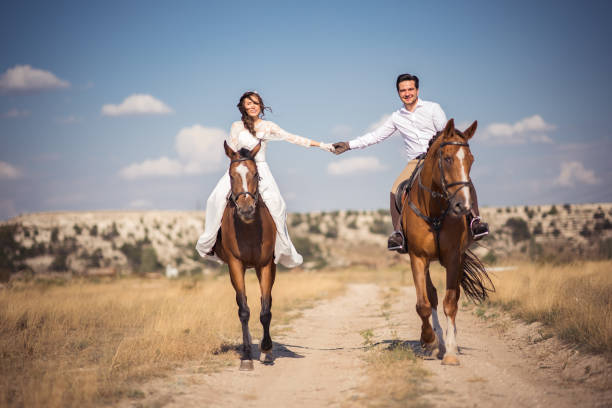 Groom And Bride On Horseback at wedding