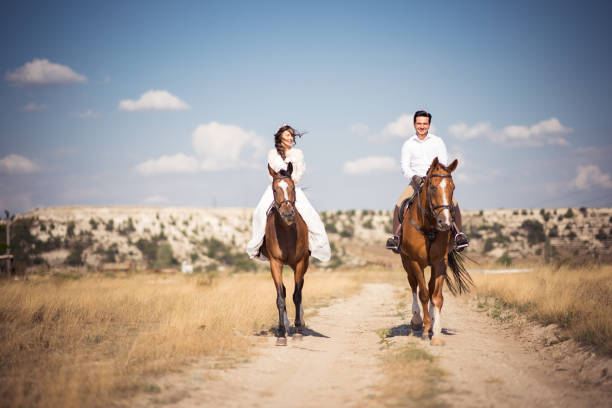istock Groom And Bride On Horseback at wedding 1028979762