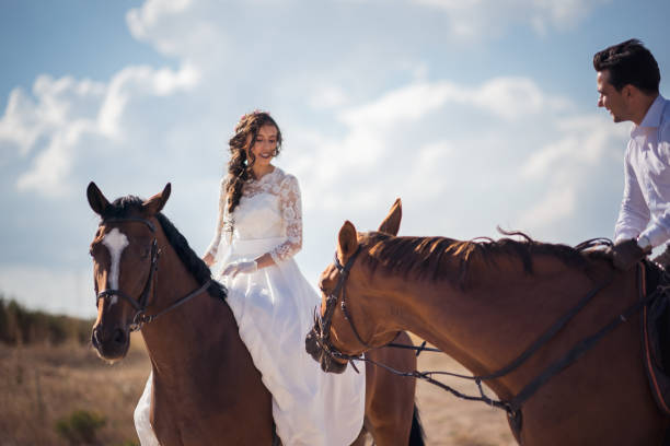istock Groom And Bride On Horseback at wedding 1028979766