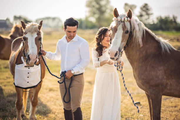 Couple loving a male and female horses