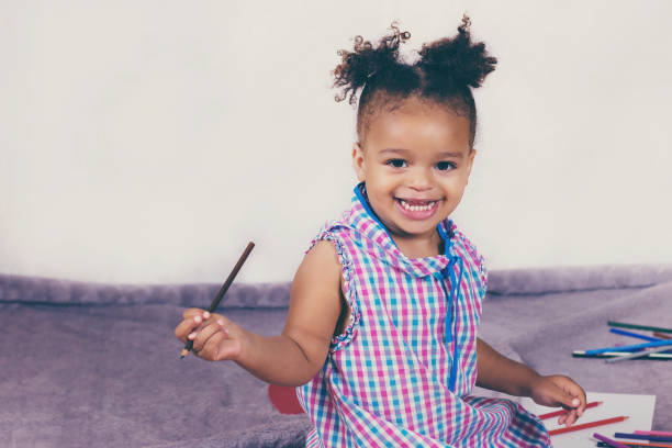 istock Beautiful child enjoying painting 1028986454