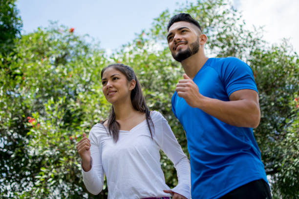 istock Couple outdoors jogging at the park 1028989014