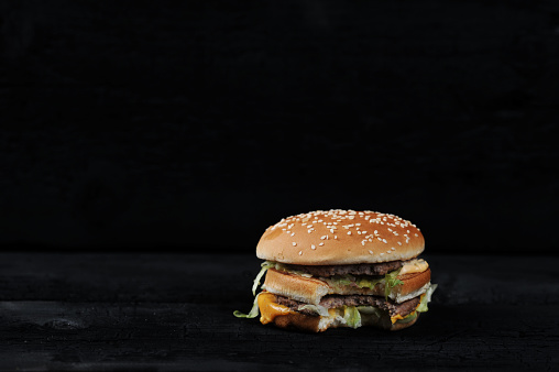 Biten Burger Bitten Burger On A Dark Rustic Stock Photo - Download Image Now ...