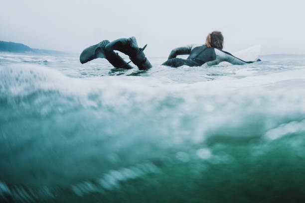 Woman Surfing At Oregon Coast on Overcast Day