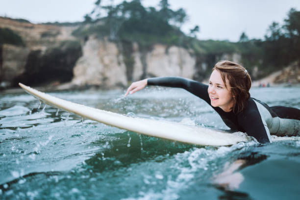 istock Woman Surfing At Oregon Coast on Overcast Day 1029014164