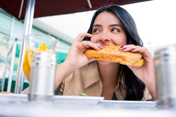 istock Woman eats a sandwich 1029022790