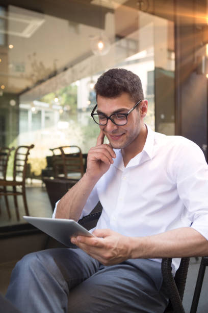 istock Businessman working on digital tablet in cafe. 1029032924