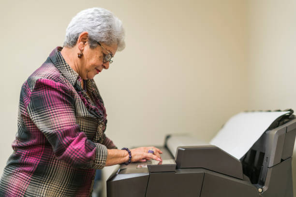 istock Senior silver-haired woman, engeneer, using the commercial wide format printer 1029035326