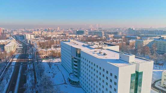 The aerial panoramic view on the residential district of the winter city covered by the snow in the bright cold sunny day.  Minsk, Belarus, Eastern Europe
