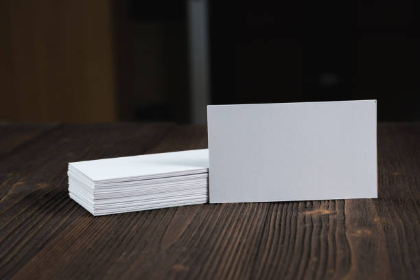 istock Blank business cards on wooden working table with copy space for add text ID. and logo, business company concept. 1029035748