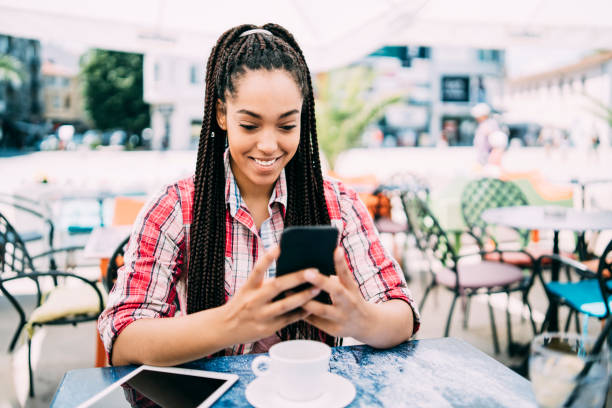 istock Smiling woman sitting on cafe and social networking 1029035918